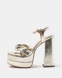 RIVER ISLAND GOLD WIDE FIT KNOT PLATFORM HEELS ~ chunky metallic party platforms ~ knotted retro evening shoes ~ women’s vintage style occasion sandals ~ high block heel