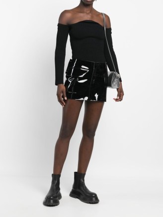 1017 ALYX 9SM embossed-logo mini skirt in black | women’s high shine skirts | glossy fashion | edgy clothes | FARFETCH - flipped