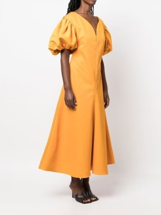 Rosie Assoulin puff-sleeve midi dress in amber yellow | flared hem dresses | short puffed sleeves | back bow detail | FARFETCH - flipped