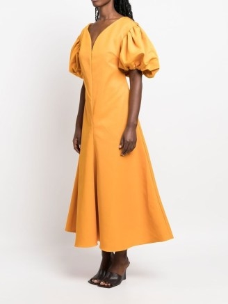 Rosie Assoulin puff-sleeve midi dress in amber yellow | flared hem dresses | short puffed sleeves | back bow detail | FARFETCH