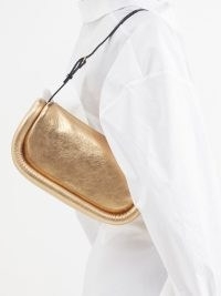 JW ANDERSON Bumper Baguette metallic-leather shoulder bag in gold – luxe 90s style handbags – glamorous 1990s style designer bags – MATCHESFASHION