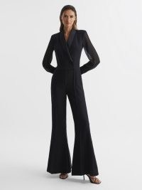 Reiss LENNON TUXEDO JUMPSUIT BLACK | long sheer sleeved flared hem evening jumpsuits | chic evening event fashion | sophisticated party clothes