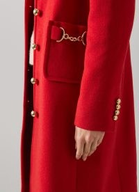 Catherine, Princess of Wales red horsebit embellished coat worn over an all black outfit, L.K. Bennett Spencer Recycled Wool Blend Snaffle-Detail Coat, on a visit to Wales, 27 September 2022 | Kate Middleton coats | royal fashion | celebrity street style clothes
