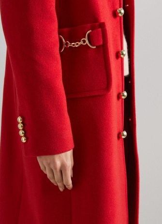 Catherine, Princess of Wales red horsebit embellished coat worn over an all black outfit, L.K. Bennett Spencer Recycled Wool Blend Snaffle-Detail Coat, on a visit to Wales, 27 September 2022 | Kate Middleton coats | royal fashion | celebrity street style clothes - flipped