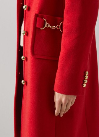 Catherine, Princess of Wales red horsebit embellished coat worn over an all black outfit, L.K. Bennett Spencer Recycled Wool Blend Snaffle-Detail Coat, on a visit to Wales, 27 September 2022 | Kate Middleton coats | royal fashion | celebrity street style clothes