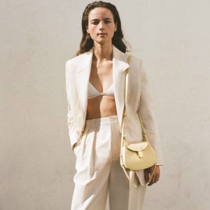 DEMELLIER The Mini Lausanne in buttermilk small grain leather ~ luxe curved saddle shaped handbags ~ chic crossbody ~ small luxury shoulder bags - flipped