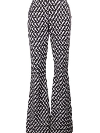 Taylor Swift’s black and white printed pants, Dorothee Schumacher jacquard jersey flared trousers. Worn with a matching high neck top and blazer, appearing on The Tonight Show with Jimmy Fallon, 24 October 2022 | celebrity retro inspired fashion | star clothing USA - flipped