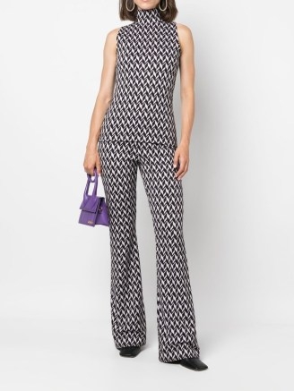 Taylor Swift’s monochrome geo print high neck top, Dorothee Schumacher sleeveless jacquard jersey top. Worn with a matching single breasted blazer and flared trousers, appearing on The Tonight Show with Jimmy Fallon, 24 October 2022 | celebrity fashion - flipped