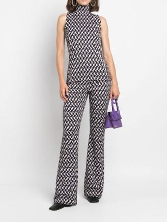 Taylor Swift’s monochrome geo print high neck top, Dorothee Schumacher sleeveless jacquard jersey top. Worn with a matching single breasted blazer and flared trousers, appearing on The Tonight Show with Jimmy Fallon, 24 October 2022 | celebrity fashion