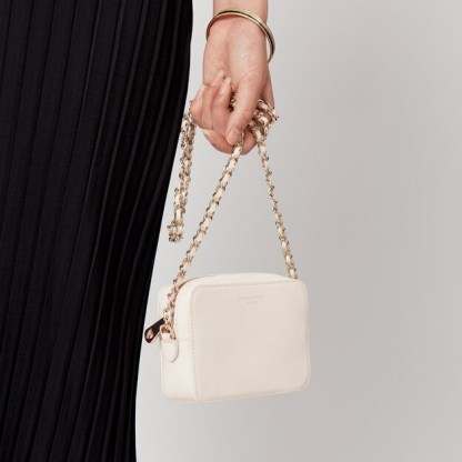 ASPINAL of LONDON Milly Bag in Smooth Ivory | small luxe camera bags | gold leather-plaited chain strap crossbody