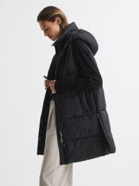 REISS ANTONIA HOODED LONG SLEEVELESS PUFFER JACKET BLACK – women’s longline quilted gilet style jackets – womens stylish padded winter outerwear