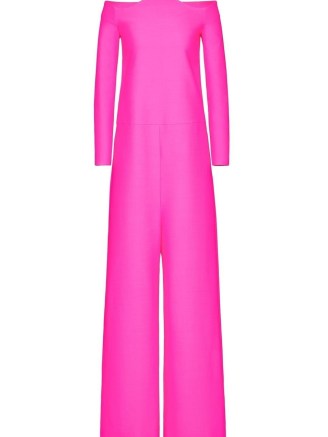 Olivia Culpo’s hot pink off the shoulder jumpsuit with sculpted neckline, Valentino Crepe Couture jumpsuit. Worn with a pair of patent platforms, long jersey gloves and carrying a leather mini sized top handle bag (all Valentino). Attending the ‘Forever Valentino’ Exhibition in Doha, Qatar, 27 October 2022 | celebrity red carpet outfits | star jumpsuits | designer fashion - flipped