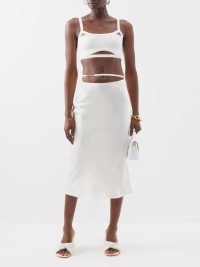 JACQUEMUS Notte side-slit satin-blend skirt in white – luxe fluid fabric split hem skirts – matchesfashion – feminine fashion – skinny strap waist detail