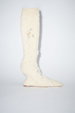 Acne Studios DISTRESSED SOCK BOOTS in Cream beige | knitted wool boot with a sculptural heel | women’s footwear with deconstructed details | knitwear fashion - flipped