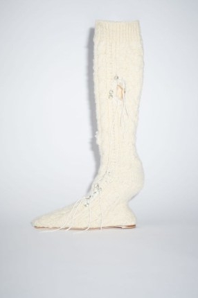 Acne Studios DISTRESSED SOCK BOOTS in Cream beige | knitted wool boot with a sculptural heel | women’s footwear with deconstructed details | knitwear fashion