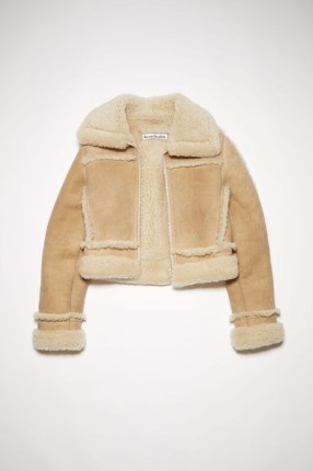 Kendall Jenner’s cream cropped jacket, Acne Studios SHEARLING LEATHER JACKET in Beige. Worn with a regular white T-shirt, tan suede front panelled jeans and brown square toe boots. Out in New York City, 9 November 2022 | Models off duty American style | celebrity street outfits | casual winter fashion