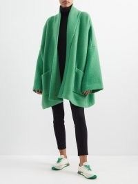 Kendall Jenner’s green knitted wide sleeved jacket, THE ROW Stowe oversized alpaca-blend coat. Worn with a matching scarf. On Justine Skye’s Instagram, 22 November 2022 | celebrity social media coats | models off duty fashion | reality star knitwear style