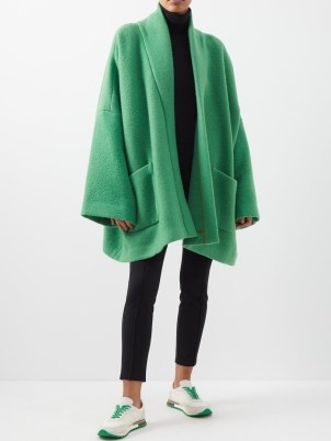 Kendall Jenner’s green knitted wide sleeved jacket, THE ROW Stowe oversized alpaca-blend coat. Worn with a matching scarf. On Justine Skye’s Instagram, 22 November 2022 | celebrity social media coats | models off duty fashion | reality star knitwear style - flipped