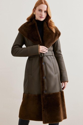 Lydia Millen Shearling And Leather Shawl Collar Belted Coat Dark Olive | luxe green longline coats | womens luxury outerwear from Karen Millen - flipped