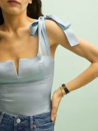 Reformation Daisy Silk Top in Horizon – light blue fitted bodice tops – shoulder strap tie detail – front V-neck cut out