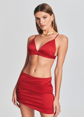 Olivia Culpo’s red bralet, SER.O.YA IRIS SILK BRALETTE. Worn with a red metallic shirt and matching trousers. On Instagram, January 2023 | celebrity bralettes | social media style - flipped