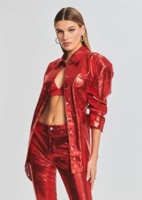 Olivia Culpo’s red metallic shirt, Retrofête MERCURY LEATHER SHIRT. Worn with a pair of matching trousers and a satin bralette. On Instagram, 8 January 2023 | celebrity social media fashion