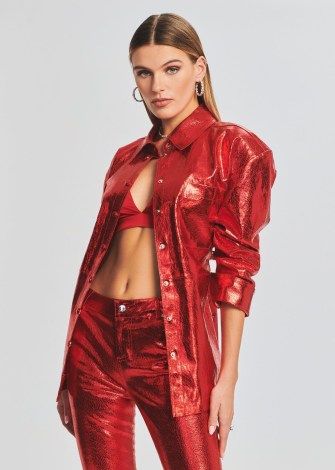 Olivia Culpo’s red metallic shirt, Retrofête MERCURY LEATHER SHIRT. Worn with a pair of matching trousers and a satin bralette. On Instagram, 8 January 2023 | celebrity social media fashion