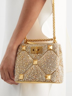 VALENTINO GARAVANI Roman Stud crystal-embellished handbag in gold – small luxury handbags – designer occasion bags – glamorous evening accessories – luxe event accessory - flipped