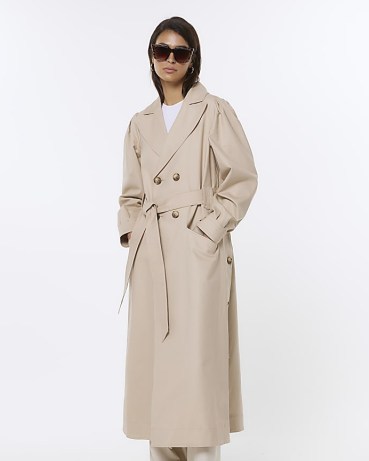 River Island BEIGE RI STUDIO BELTED TRENCH COAT | women’s classic tie waist longline coats | cuffed sleeves | gathered shoulder detail - flipped