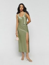 Reformation Kaia Two Piece in Artichoke / green satin fashion co-ord / luxury clothing sets / women’s silky co-ords / luxe tank top and bias cut midi skirt / matching slinky tops and skirts / thigh high slit