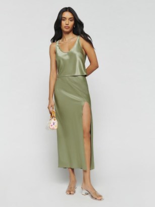 Reformation Kaia Two Piece in Artichoke / green satin fashion co-ord / luxury clothing sets / women’s silky co-ords / luxe tank top and bias cut midi skirt / matching slinky tops and skirts / thigh high slit