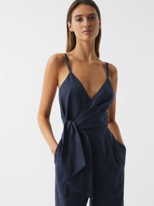 REISS EMILIA V-NECK LINEN JUMPSUIT ~ plunging wrap front jumpsuits ~ tie waist detail ~ women’s dark blue occasion clothes ~ glamorous evening fashion ~ womens strappy party clothing ~ shoulder straps with chain details - flipped