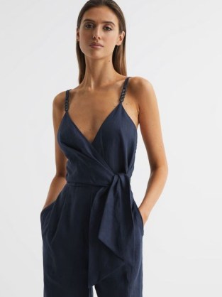 REISS EMILIA V-NECK LINEN JUMPSUIT ~ plunging wrap front jumpsuits ~ tie waist detail ~ women’s dark blue occasion clothes ~ glamorous evening fashion ~ womens strappy party clothing ~ shoulder straps with chain details