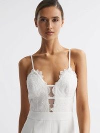 Reiss CORA LACE PLUNGE NECK JUMPSUIT IVORY | luxury spaghetti shoulder strap jumpsuits | womens luxe evening fashion | luxury occasion clothes | feminine event clothing | plunging neckline