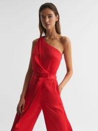 REISS ELIZA OFF-THE-SHOULDER JUMPSUIT RED – one shoulder tie waist jumpsuits – women’s luxury occasion clothes – womens party fashion – glamorous evening all-in-one clothing