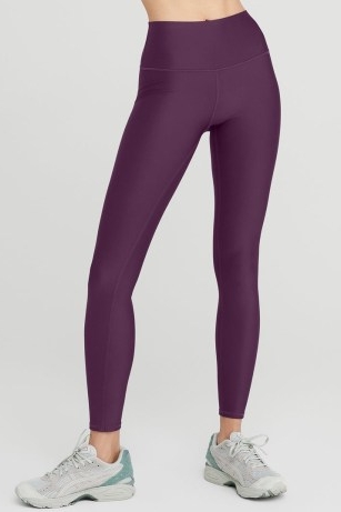 Olivia Wilde’s purple leggings, alo yoga 7/8 High-Waist Airlift Legging in dark plum. Worn with a green long sleeve crewneck sweatshirt and a pair of blue and yellow stripe trainers. Leaving the Tracy Anderson Method Studio in Los Angeles, 13th April 2023 | casual celebrity street style | sporty outfits | Olivia Wilde sports clothing