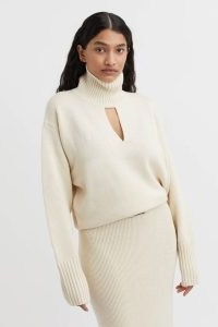 CAMILLA AND MARC Kalina Knit Cutout Turtleneck in Cream.| women’s high neck keyhole cut out sweater | womens luxury knitwear | front cutout jumpers | luxe thumb hole sweaters