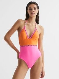 REISS RAY COLOURBLOCK HALTER SWIMSUIT ORANGE/PINK – plunging halterneck swimsuits / colour block swimwear