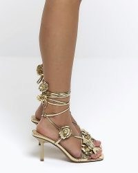 RIVER ISLAND GOLD FLOWER TIE UP HEELED SANDALS ~ metalllic ankle wrap high heel shoes ~ glamorous party footwear