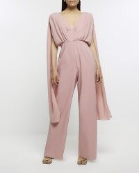 River Island PINK CAPE JUMPSUIT | plunge front jumpsuits with draped details | women’s evening occasion fashion | deep plunging neckline
