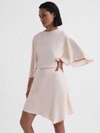REISS CHRISTY CAPE SLEEVE ASYMMETRIC MINI DRESS in NUDE – asymmetrical evening clothes – floaty wide sleeve occasion dresses