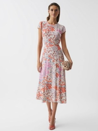 Reiss LUNA FLORAL PRINT CAP SLEEVE DRESS is a stunning piece of women’s fashion that has been designed and crafted with great care and attention to detail. This dress is a perfect example of the quality and elegance that Reiss is known for, and it is sure to make any woman feel beautiful and confident. At first glance, the dress appears to be a simple and classic design, but upon closer inspection, it is clear that every aspect of this dress has been carefully considered. The floral print, for example, is a work of art. The intricate design features a variety of different flowers, all of which have been beautifully arranged to create a stunning overall effect. The print is both bold and delicate, with bright pops of color interspersed with more subtle tones. The cap sleeves of the dress are another standout feature. They provide just the right amount of coverage for the arms while still allowing for a breezy and comfortable fit. The sleeves are cut in a way that is both flattering and feminine, with a slight gather at the top that creates a soft and romantic look. The shape of the dress is also noteworthy. It is cut to be fitted at the waist and then flares out gently to create a flattering A-line silhouette. This shape is both elegant and timeless, and it is sure to flatter a variety of different body types. The dress is also designed to be worn at knee length, making it a versatile option that can be worn to a variety of different events. When it comes to materials, Reiss has spared no expense. The dress is made from a high-quality silk blend that feels incredibly soft and luxurious against the skin. This material has a slight sheen to it that catches the light beautifully, adding to the overall elegance of the dress. In terms of styling, the Reiss LUNA FLORAL PRINT CAP SLEEVE DRESS is a versatile piece that can be dressed up or down depending on the occasion. For a more formal event, it can be paired with a pair of heels and some statement jewelry to create a sophisticated and polished look. For a more casual occasion, it can be paired with a pair of sandals and a denim jacket for a more relaxed and effortless vibe. Overall, the Reiss LUNA FLORAL PRINT CAP SLEEVE DRESS is a stunning piece of women’s fashion that is sure to make a statement. Its attention to detail, high-quality materials, and classic design make it a versatile piece that can be worn to a variety of different events. Whether you’re looking for a dress to wear to a wedding, a graduation, or a summer garden party, the Reiss LUNA FLORAL PRINT CAP SLEEVE DRESS is sure to be a perfect choice.