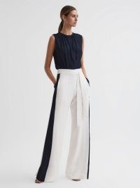 Reiss IVY WIDE LEG SIDE STRIPE JUMPSUIT NAVY/WHITE – women’s elegant sleeveless colour block jumpsuits – chic occasion clothes – womens sophistcated event clothing – belted self tie waist