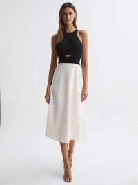 REISS VIENNA HALTER NECK CUT OUT MIDI DRESS in BLACK/WHITE – sleeveless monochrome occasion dresses – colour block evening clothes – women’s chic cutout party clothing