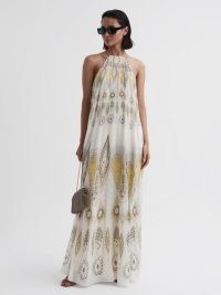 LIZA PRINTED HALTER NECK MAXI DRESS in YELLOW – chic summer occasionwear – women’s long length halterneck occasion dresses – self tie back detail – elegant holiday evening clothes – warm weather event wear