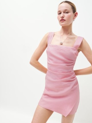 Reformation Kerrigan Linen Dress in Babygirl – pink shoulder strap mini dresses with side ruching and a faux wrap skirt – ruched fashion – fitted party clothes - flipped