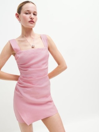 Reformation Kerrigan Linen Dress in Babygirl – pink shoulder strap mini dresses with side ruching and a faux wrap skirt – ruched fashion – fitted party clothes