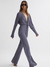 REISS FRANCES WIDE LEG POLKA DOT JUMPSUIT in Navy / dark blue spot print plunge neckline jumpsuits / chic summer occasion clothes / all-in-one event fashion