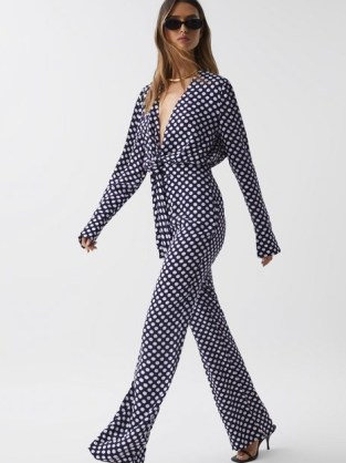 REISS FRANCES WIDE LEG POLKA DOT JUMPSUIT in Navy / dark blue spot print plunge neckline jumpsuits / chic summer occasion clothes / all-in-one event fashion - flipped