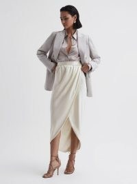 Reiss TYRA SILK HIGH-LOW WRAP SKIRT in Ivory – luxe silky occasion skirts – high low hem – asymmetric hemline – luxury occasionwear – women’s drapey event clothes